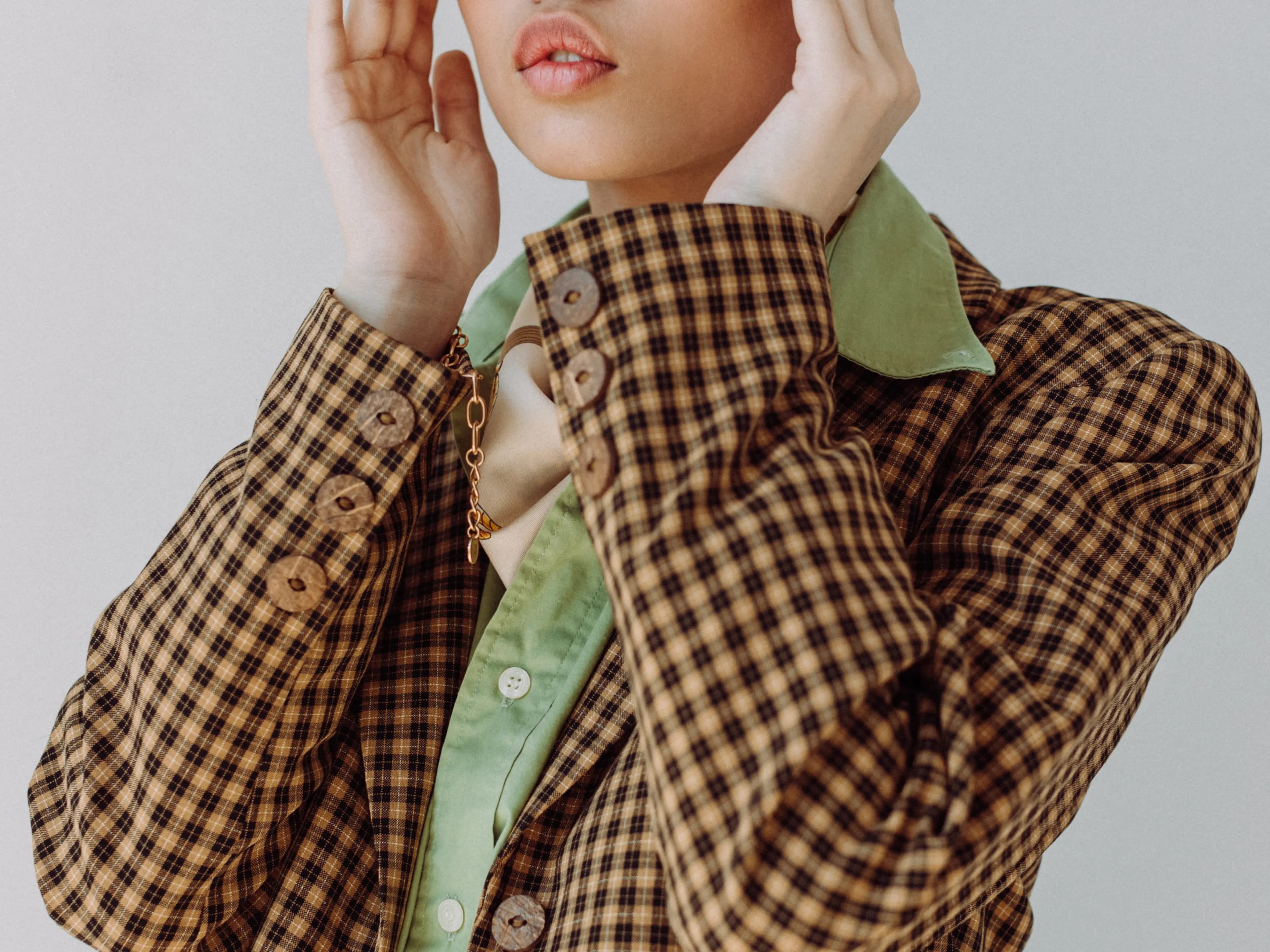 Green box image of a woman wearing a vintage jacket